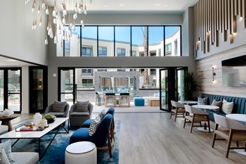 A modern living room with a large window and a view of the city.